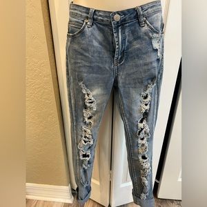 Almost Famous distressed and heavy ripping in the leg